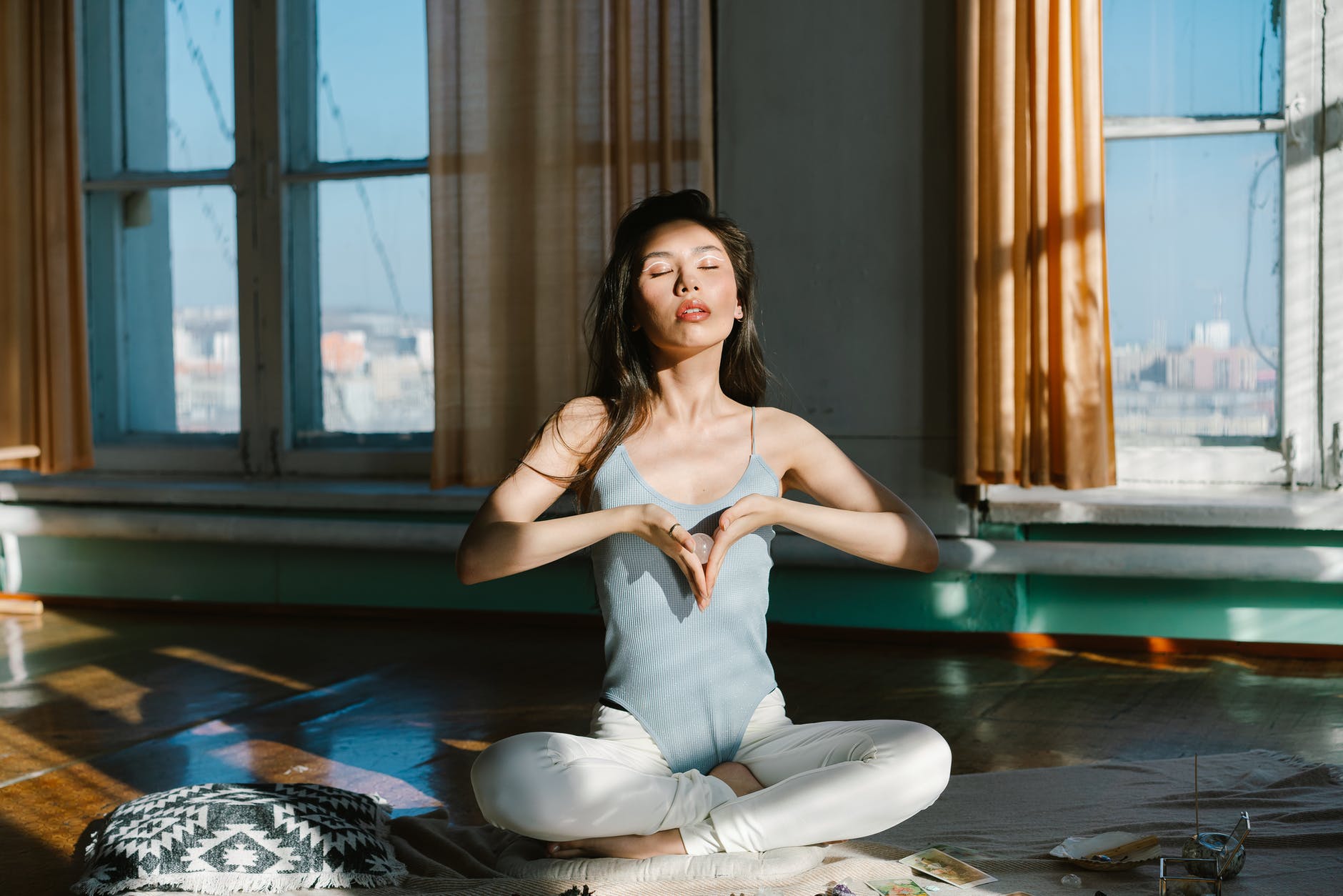 asian woman with stone practicing meditation