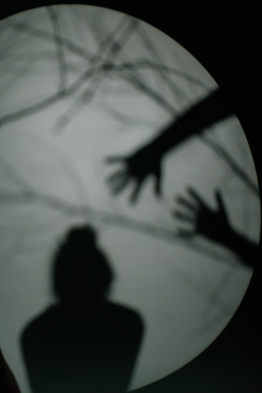 shadow of a person and hands on glass