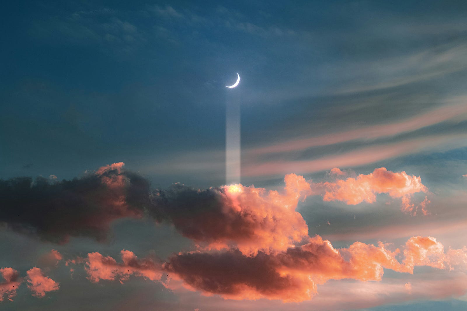crescent moon in dark blue sky with light beam down into pink clouds